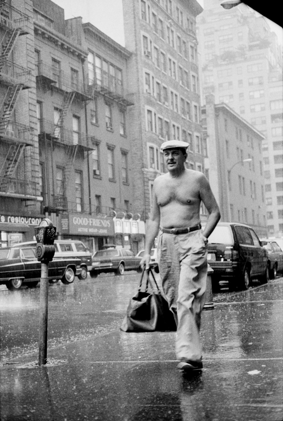 Shirtless man walking under the rain, 1990